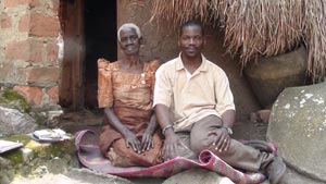 Damascus-Kafumbe-(Right)-with-One-of-His-Interviewees-at-A-Royal-Shrine-in-Buteregga-Mitwebiri,-Wakiso-District